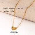 Gold heart pendant necklace on beige fabric showing dimensions and weight 2.1g - Necklace