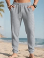 Close-up of light grey waffle texture fabric on men's drawstring jogger pants - Light Gray