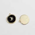 Detail of round star and moon pendant with black enamel finish and gold plating - Black Celestial Moon