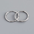 Macro view of polished S925 sterling silver hoop earrings with seamless clasp design - 15mm Inner Diameter (Platinum Color)