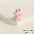 Detailed view of pink resin pig figurine with bow, size 30x20x35mm, weight approx 11g - Lollipop Pink Pig