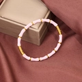 Pink enamel bamboo-style gold bangle with hidden clasp on silk background - Pink