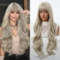 Close-up of platinum blonde long wavy wig with bangs on model and mannequin stand - Light Gold Beige White