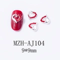 Macro detail of hollow red heart nail charms with silver base and rhinestone inlay - Minimalist Alloy Rhinestone Heart (AJ104)