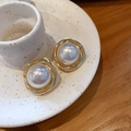 Detail shot of a large white pearl centered in a golden multi-layer spiral hoop earring - 19# Gold Pearl Hoops (Real Gold Plated)