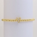 Macro view of gold beaded elastic bracelet with a micro-pave zircon letter Y pendant - Letter Y