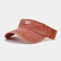 Detailed close-up of crown embroidery on terracotta washed cotton sun visor hat - Adjustable / Orange