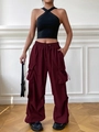 Close-up of deep red cargo pants featuring utility pockets and elastic drawstring waist - S / Burgundy