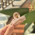 Close-up of a mini pink bow hair claw clip with golden metal spring in natural light - Stone Gray-Bow Style