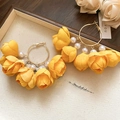 Detail of yellow fabric flower earrings with white pearls and large golden hoops - Yellow-Bud (925 Sterling Silver Earring Post)