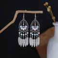 Detail of silver bohemian dangle earrings with feather tassels and beads on wood - Pink Blue White Floral Feather Style (E6136-2)