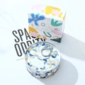 Detail of artistic soy wax candle in tin can with matching creative gift box packaging - Amber Ebony