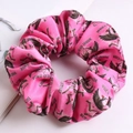 Detail of pink satin scrunchie featuring Cupid and rose patterns for Valentine's Day - Angel Rose Red