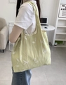 Close-up of a light green canvas tote bag with elegant white floral embroidery details - Embroidery Green