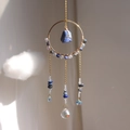 Detail of golden ring suncatcher with blue stone and faceted crystal prism ball - Lapis Lazuli