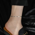 Elegant silver snake chain starfish anklet on model with black silk background - 4mm Blade Chain / Steel