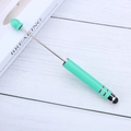 Lake green touchscreen bead pen with a black rubber stylus tip on a white wood background - Light Green