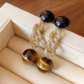 Detailed macro of vintage style drop earrings with amber beads on a velvet jewelry stand - Black Patchwork Acrylic Chain Tiger Eye Pattern Earrings (13# Silver Pin)