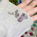 Detailed macro view of pink teardrop zircon clip-on earrings with silver-toned finish - Clip-On Earrings / Pink