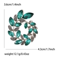 Silver olive branch wreath brooch with green crystals and rhinestones in circular design - Green