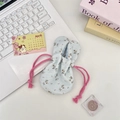 Floral bunny ear drawstring storage bag on a bright desk with lifestyle props - Blue