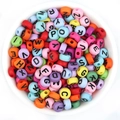 Colorful acrylic letter beads in a white bowl for DIY jewelry and bracelet making - Colorful + Black Text
