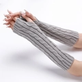 Detailed view of grey cable-knit arm warmers with thumb holes for winter comfort - Light Gray