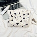 Quilted makeup bag with cartoon cat and dog patterns on a beige travel storage pouch - Black Cat & Dog