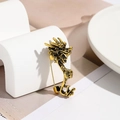 Vintage golden dragon brooch with black oil-dripped texture on a minimalist display - Antique Gold Dragon