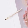 Elegant gold metal hair clip with a single row of white pearls on a fashion magazine - 4mm Pearl Bobby Pin