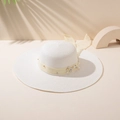 Close-up of white straw sun hat with yellow satin bow, flowers, and pearl accents - M (56-58cm) / White