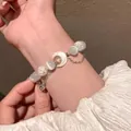 Elegante pulsera plateada de doble capa con dije de luna y cuentas de opale blanco - Pulsera de Cuentas de Ojo de Gato con Luna y Cascabel de Estilo Francés