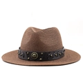 Detail of western straw hat with leather band and brass studs on a dark brown surface - M (56-58cm) / Brown