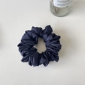Close-up of navy blue satin scrunchie with elegant pleated fabric on a clean background - Dark Blue