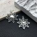 Silver vintage sun charms for DIY jewelry making on professional texture background - Sun 8228 Silver 31x35mm