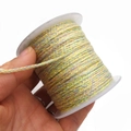 Close-up of multicolor braided cotton cord on spool showing detailed texture and weave - Approx. 2.0mm / Yellow, Green, Pink and Blue