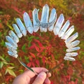 Macro shot of iridescent quartz crystals and silver moon on a wicca witch crown headband - Aura White + White K Moon