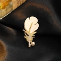 Elegant feather brooch with resin petals, sparkling crystals and a white pearl on silk - Feather