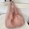 Detailed view of a pink mesh tote bag with a soft tulle overlay and minimalist design. - Pink