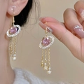Elegant planet tassel earrings with pink oval crystal and gold fringe star accents - Pink Planet Tassel Style