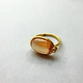 Macro view of 18K gold plated ring with oval orange gemstone and clear zircon accent - US 6 / Orange Pink