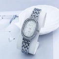 Macro detail of oval quartz watch dial featuring diamond bezel and silver link band - Silver