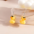 Detailed view of yellow duck earrings with black sunglasses and silver hooks for women - Sunglasses Little Yellow Duck