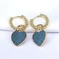 Pair of gold heart hoop earrings with blue pavé zircons on white fabric background - Blue