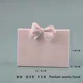 Pink resin pendant display stand with a bow detail on a soft blue background - Large Bowknot Necklace Stand