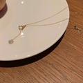 Detail of heart shell pendant necklace with sparkling zircons and a vintage OT clasp - Gold