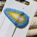 Handmade crochet teardrop hair clip in blue, yellow, and ivory knit on display card - 8# White Center Water Drop Blue
