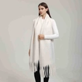 Close-up of cream white long scarf featuring thick tassel fringe in soft knit texture - White