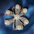 Rose gold flower brooch with white pearls and sparkling crystals on blue silk - Gardenia Brooch