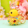 Sparkling crystal duck keychain with golden crown and colorful gems on floral background - Yellow Duck
